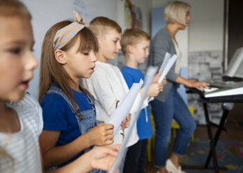 side view kids singing together sunday school